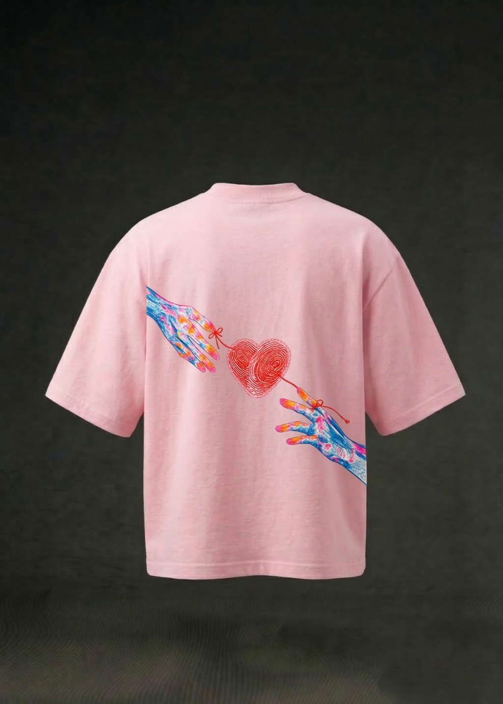Pink oversized t-shirt with colorful hand graphic and red heart design on the back