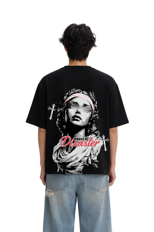 Oversized black streetwear t-shirt with 'Angelic Disaster' graphic, worn by a male model