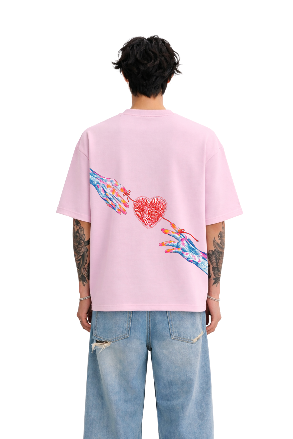Man wearing oversized pink streetwear t-shirt with colorful hand and heart graphic on back